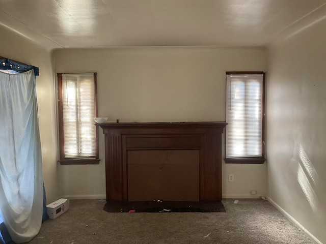 unfurnished living room featuring carpet flooring