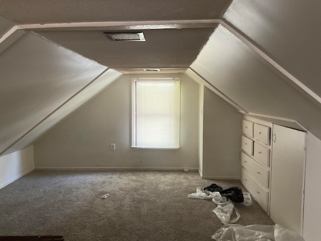 additional living space with carpet and lofted ceiling