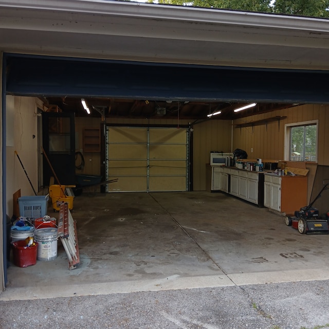 garage featuring wood walls and a garage door opener