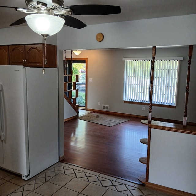 kitchen with ceiling fan, light hardwood / wood-style floors, and white refrigerator