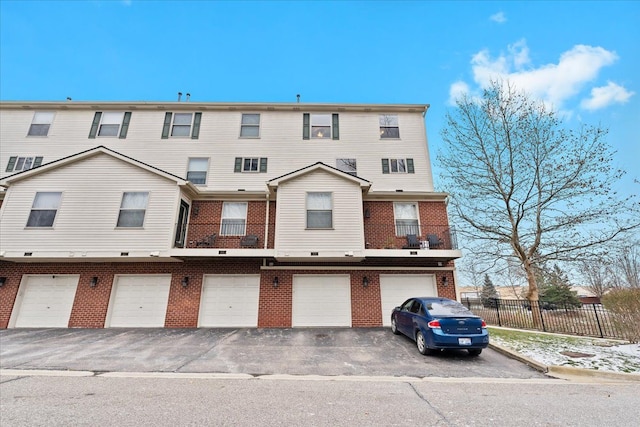 townhome / multi-family property with a garage and a balcony