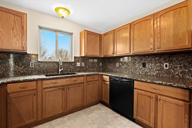 kitchen featuring sink, black dishwasher, backsplash, and dark stone countertops