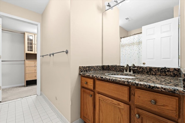 bathroom with tile patterned floors, vanity, and a shower with curtain