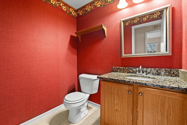 bathroom with tile patterned floors, vanity, and toilet