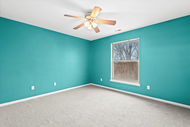 spare room featuring carpet flooring and ceiling fan