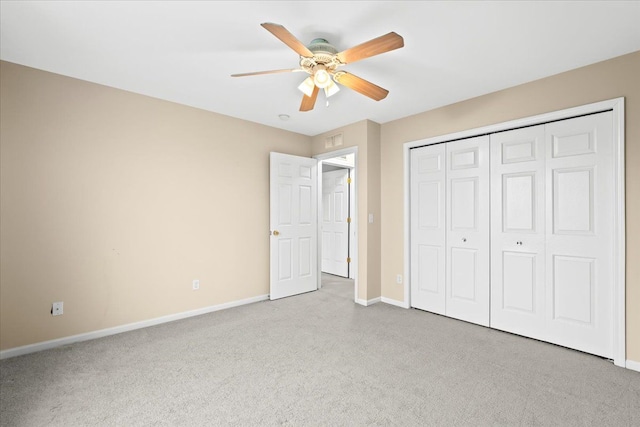 unfurnished bedroom with ceiling fan, light colored carpet, and a closet