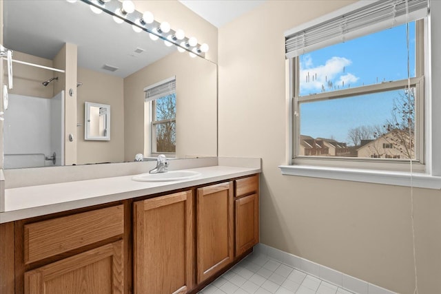 bathroom featuring a shower, vanity, and tile patterned floors