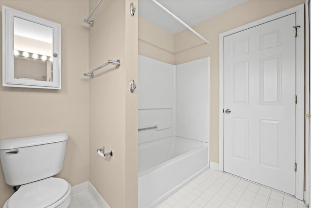 bathroom featuring tile patterned floors, bathing tub / shower combination, and toilet