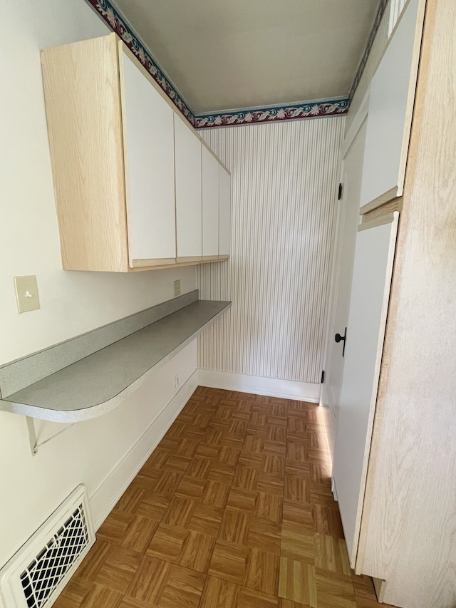 laundry room with dark parquet flooring