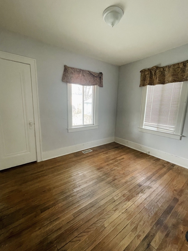 empty room featuring dark hardwood / wood-style flooring