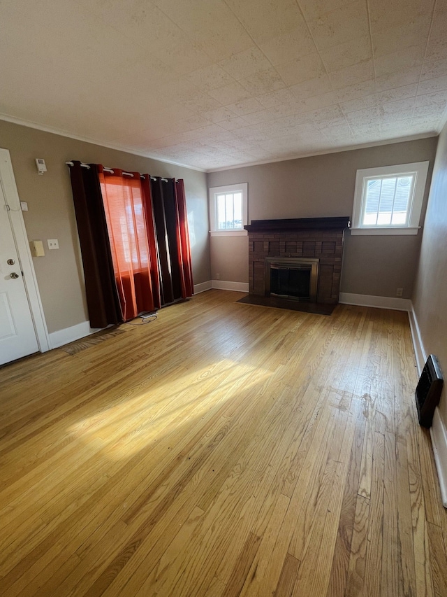 unfurnished living room with a wealth of natural light and light hardwood / wood-style flooring