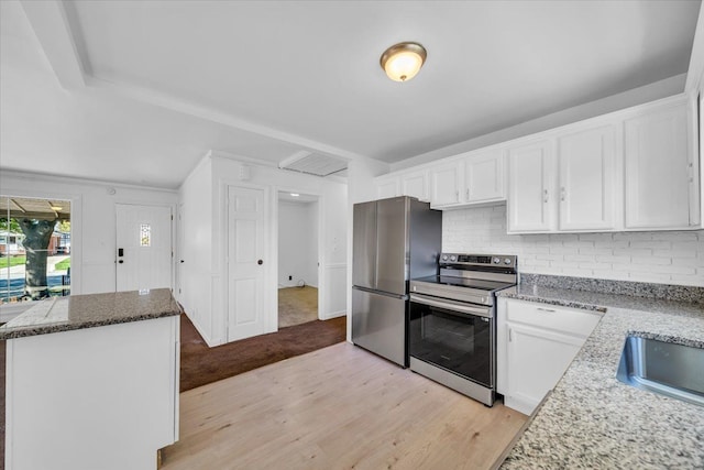 kitchen featuring decorative backsplash, white cabinetry, light wood-type flooring, and appliances with stainless steel finishes