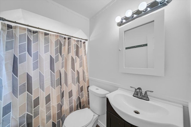 bathroom featuring curtained shower, vanity, and toilet