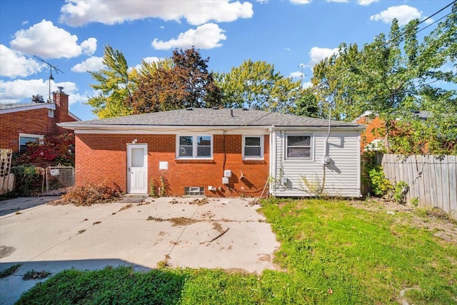 back of house featuring a lawn and a patio