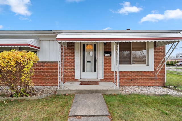 property entrance with a yard