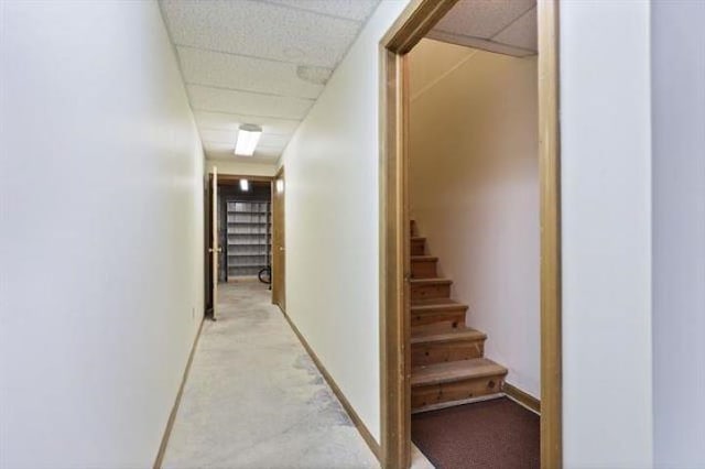 corridor with a paneled ceiling