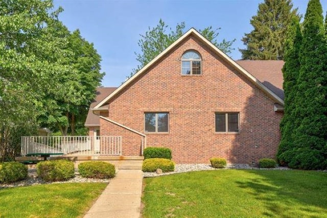 view of side of home featuring a yard and a wooden deck