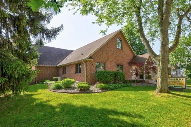 view of home's exterior with a lawn