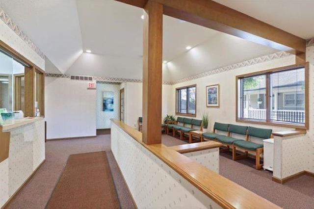 carpeted living room featuring lofted ceiling