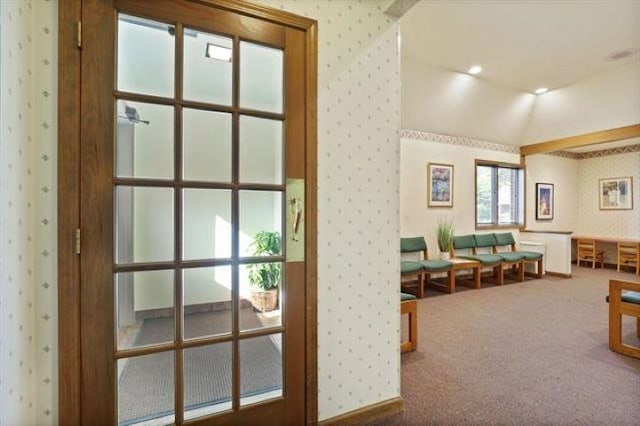 interior space with carpet and lofted ceiling