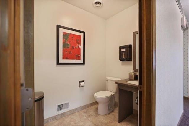 bathroom with tile patterned floors, vanity, and toilet