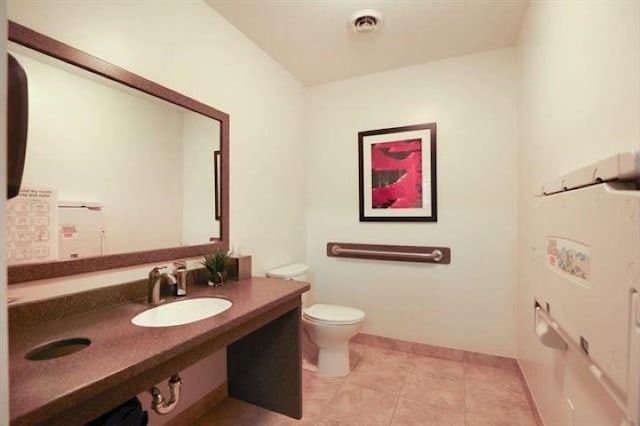 bathroom with sink, tile patterned flooring, and toilet