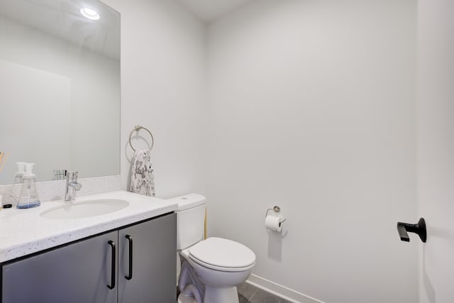 bathroom with tile patterned floors, vanity, and toilet