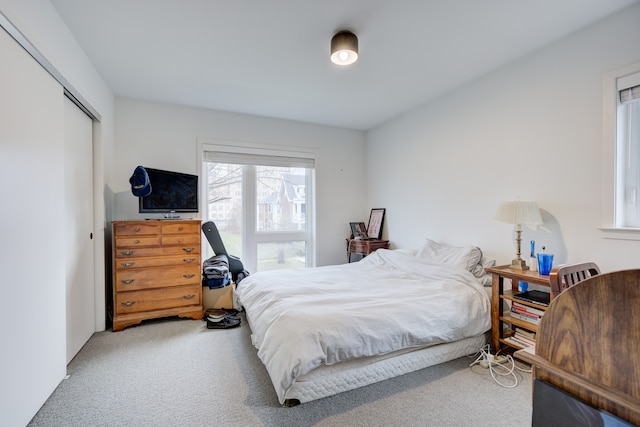 carpeted bedroom with a closet