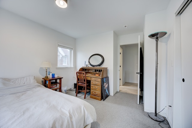 bedroom with light carpet and a closet