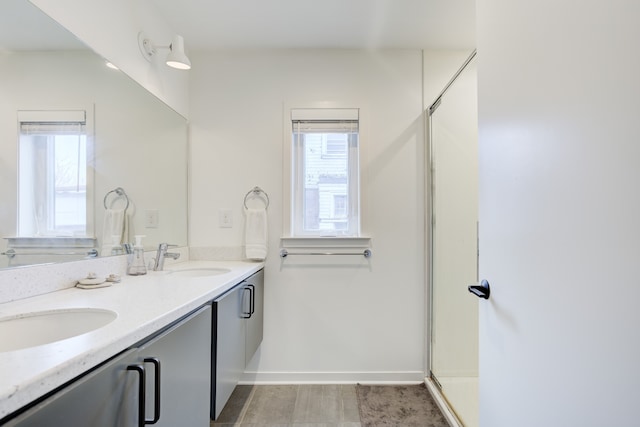 bathroom featuring vanity and an enclosed shower