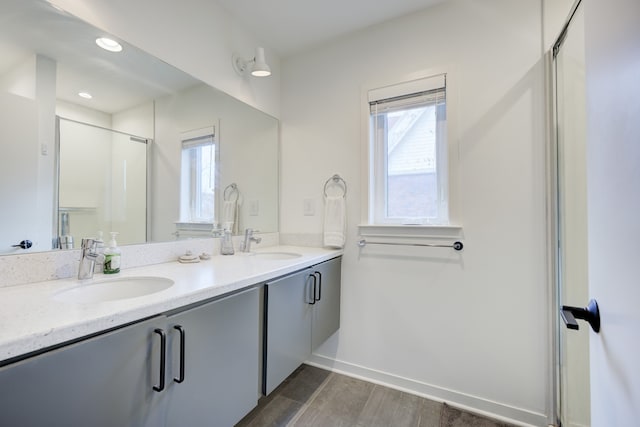 bathroom with vanity, hardwood / wood-style flooring, and walk in shower