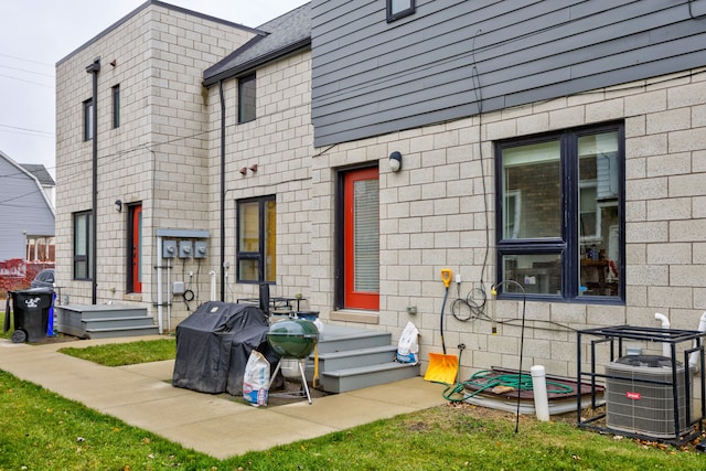 rear view of house featuring cooling unit