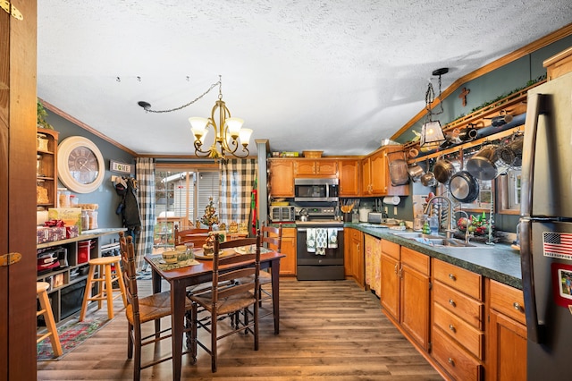 kitchen with hardwood / wood-style flooring, crown molding, stainless steel appliances, and a wealth of natural light