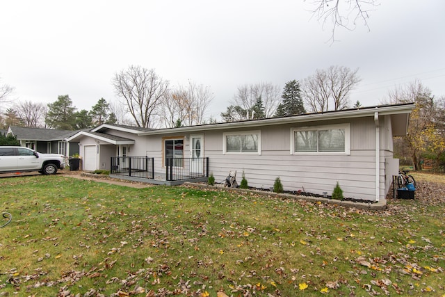 single story home featuring a garage and a front lawn