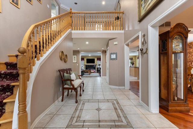 tiled foyer with a high ceiling