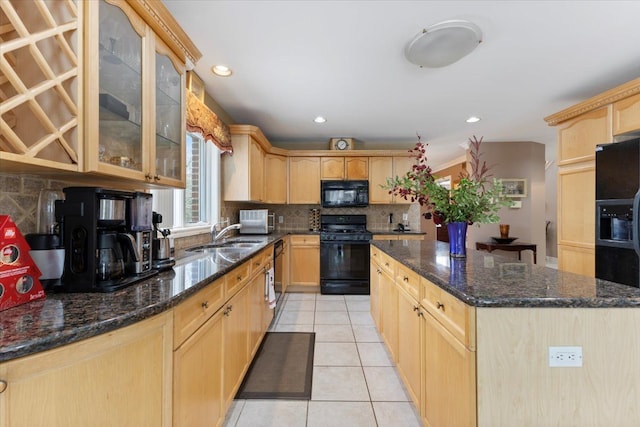 kitchen with light brown cabinetry, sink, tasteful backsplash, and black appliances