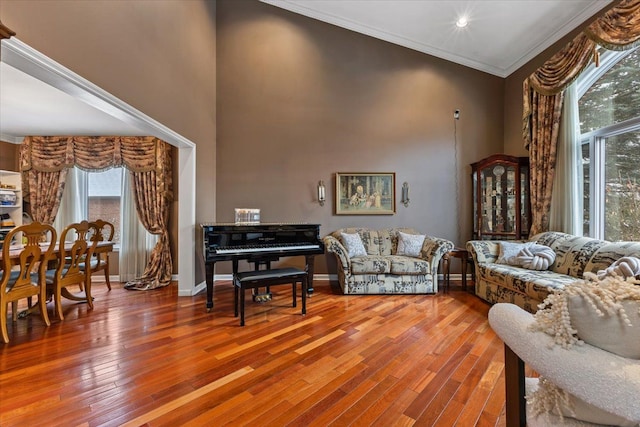 living room featuring wood-type flooring and ornamental molding