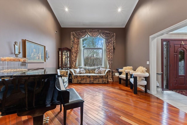 living room with light wood-type flooring and ornamental molding