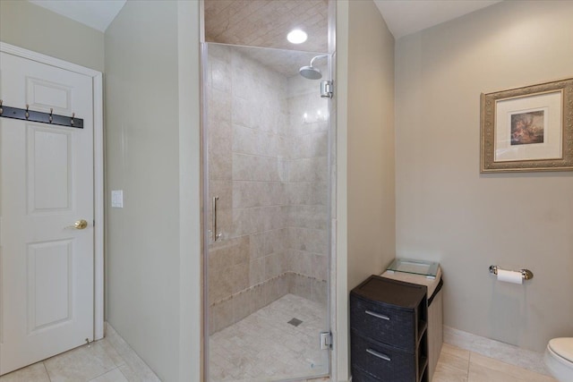 bathroom with toilet, tile patterned floors, and an enclosed shower