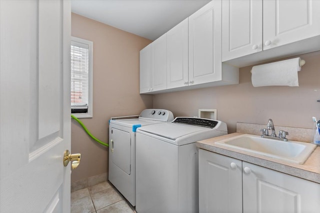 laundry area with washer and dryer, cabinets, light tile patterned floors, and sink