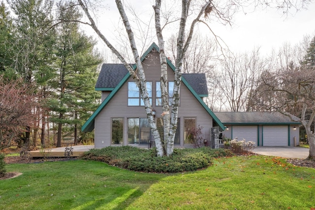 english style home with a front yard and a garage