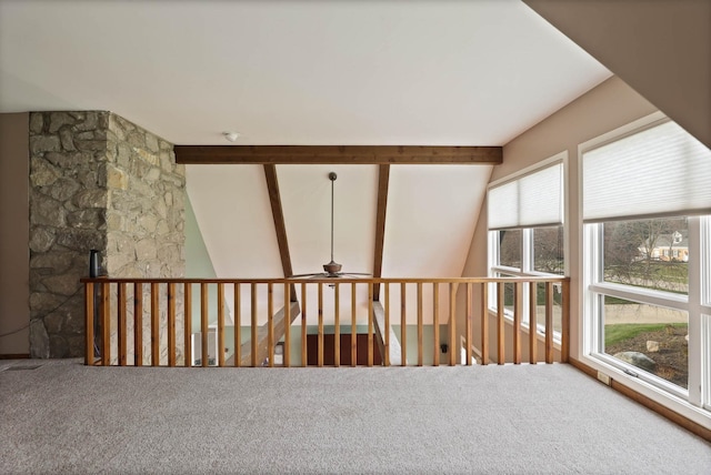 interior space with vaulted ceiling with beams, ceiling fan, and plenty of natural light