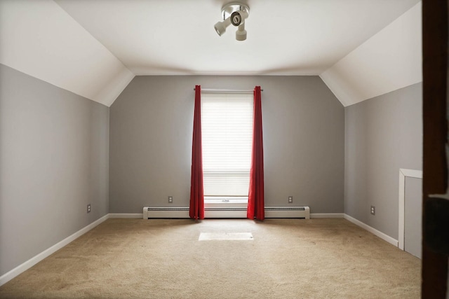 additional living space featuring carpet floors, a baseboard radiator, and vaulted ceiling