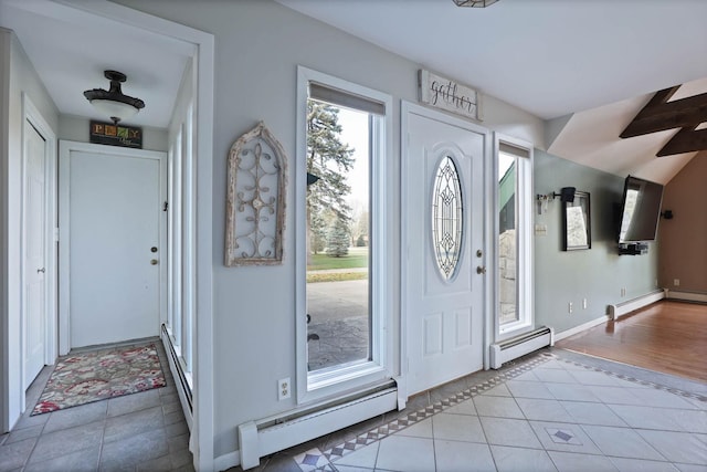 foyer entrance with light tile patterned floors and a baseboard radiator