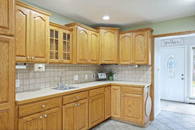 kitchen with tasteful backsplash, sink, and light tile patterned flooring