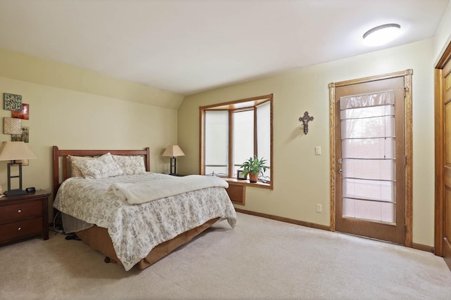 bedroom featuring lofted ceiling and light carpet