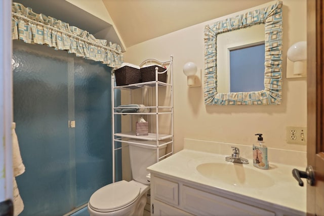 bathroom with vanity, toilet, and lofted ceiling