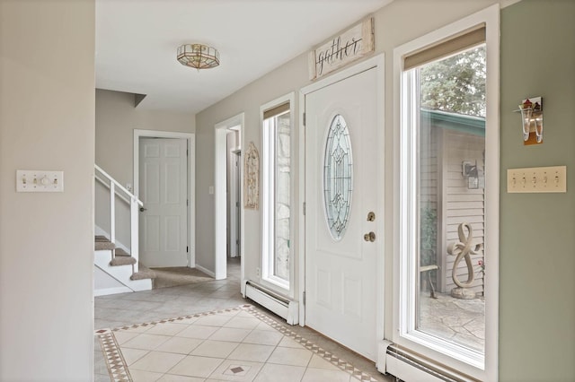 entrance foyer with light tile patterned floors and a baseboard radiator