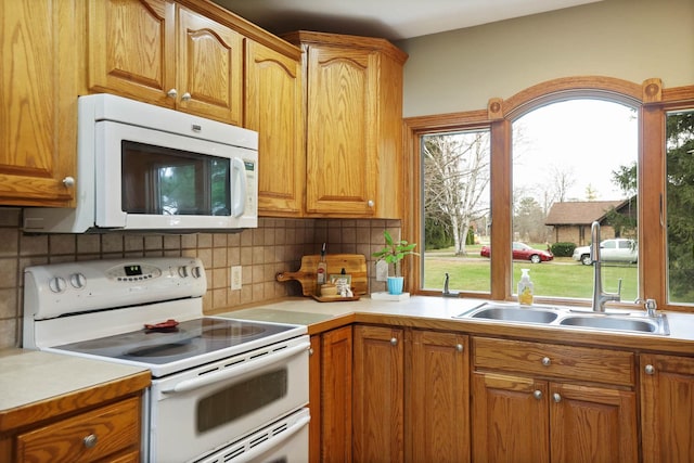 kitchen featuring tasteful backsplash and white appliances