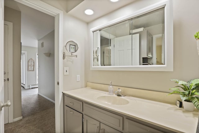 bathroom with vanity and a baseboard heating unit